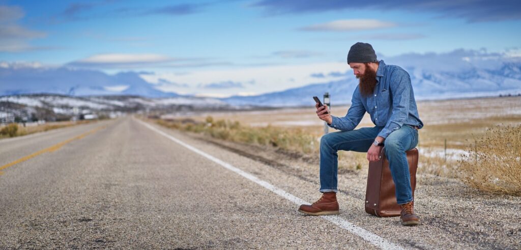 Traveller with smartphone using apps