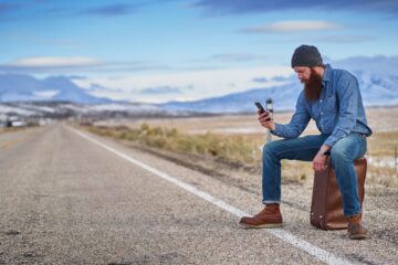 Traveller with smartphone using apps