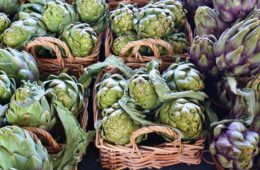 Vegan travel purple artichokes in Italian market