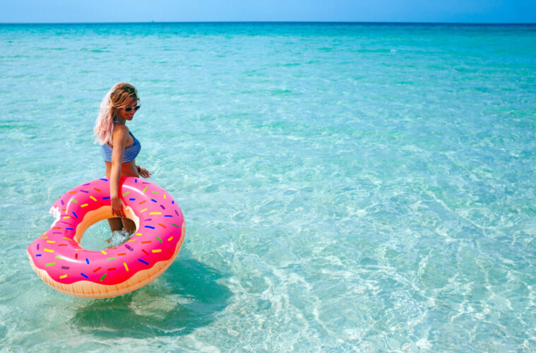 Woman in sea with inflatable doughnut