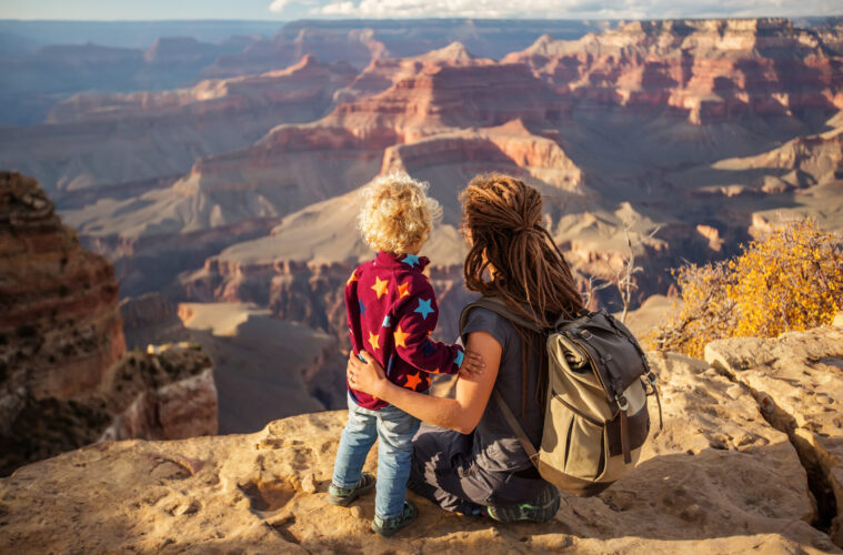 Mother and child standing on edge of Grand Canyon