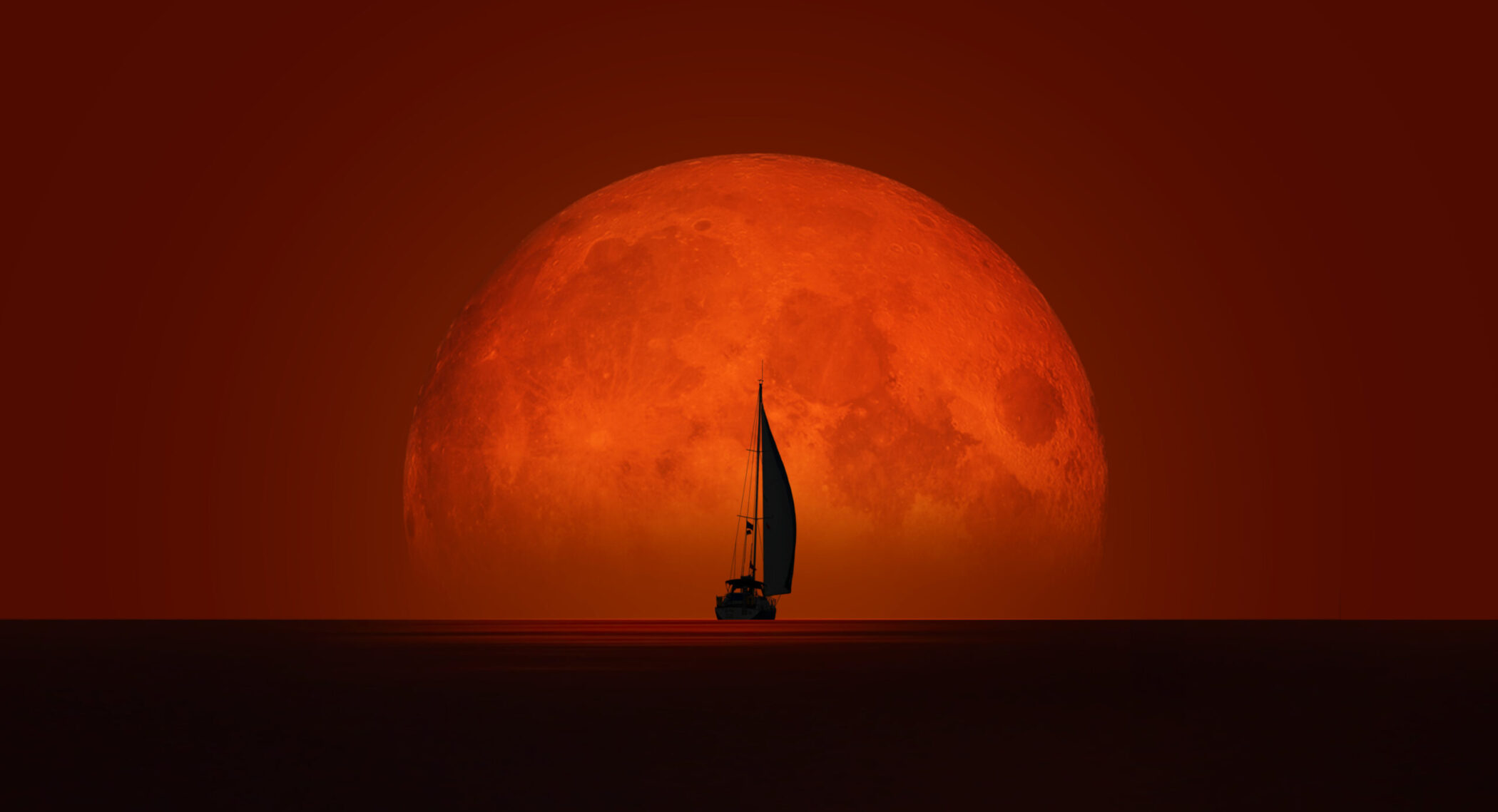 Yacht against a red moon
