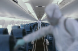 HazMat team decontaminating airplane cabin during virus outbreak
