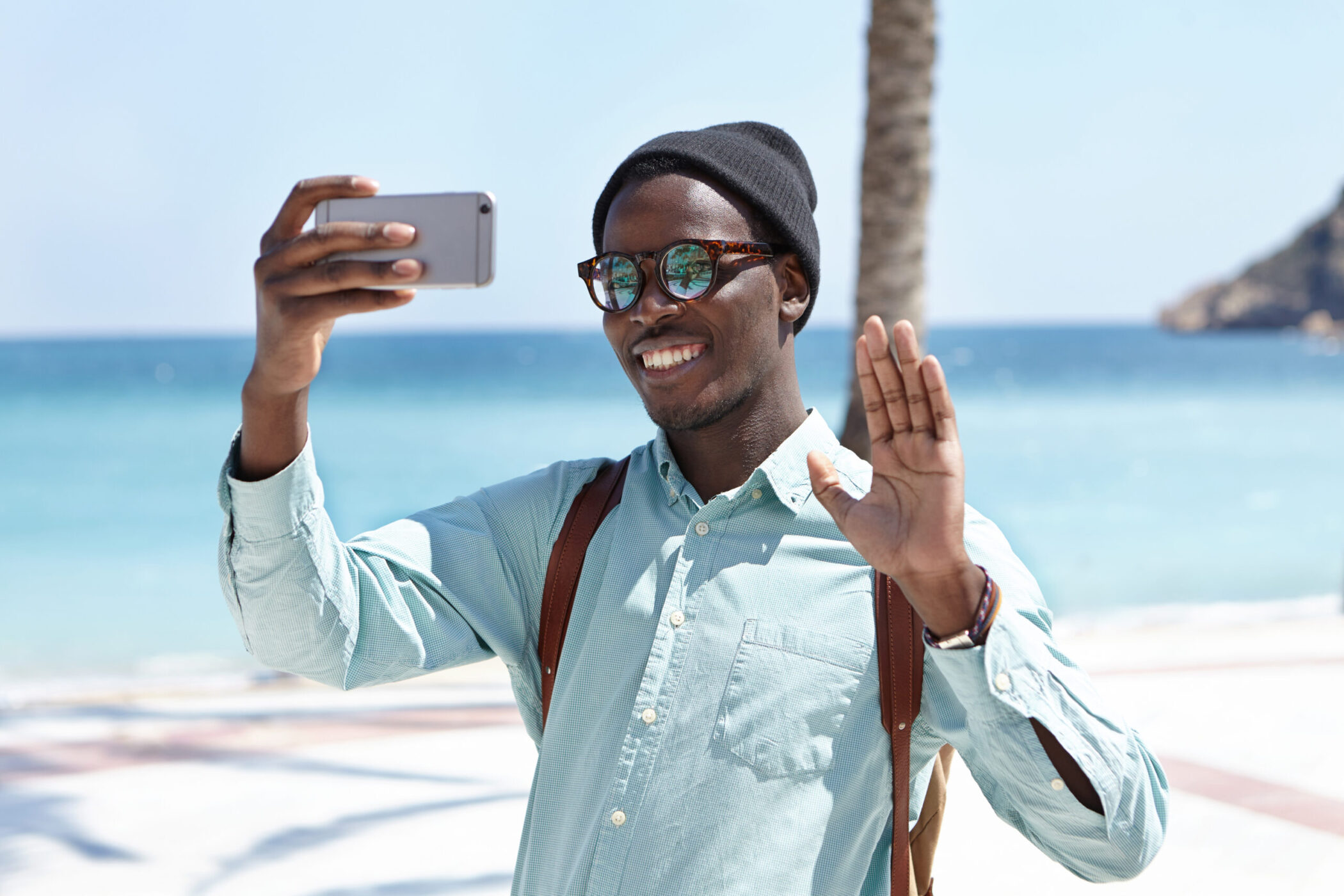 Man on beach doing video call