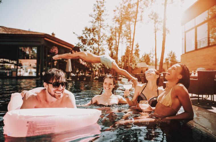 Group of Young Happy People Swimming in Pool