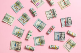 US dollars on a pink background
