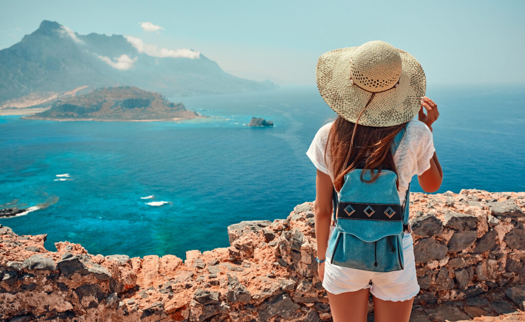 Girl with backpack, tourism by sea