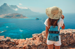 Girl with backpack, tourism by sea