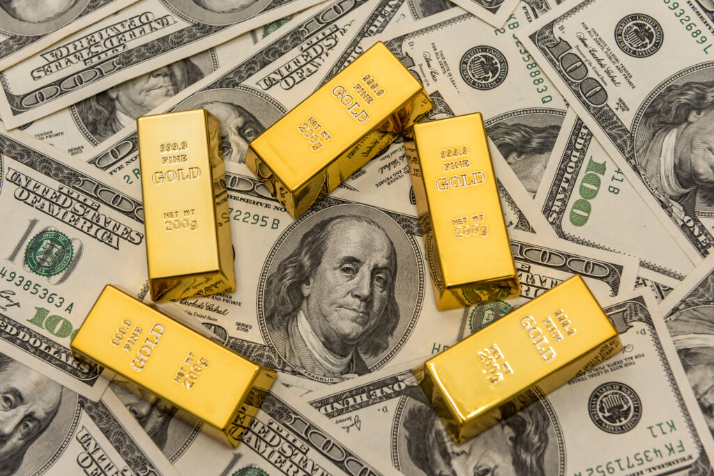 gold bullion bars on usd money bills. Success concept