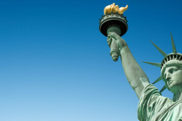 Close up of the Statue of Liberty in New York, USA. Blue sky background with copy space