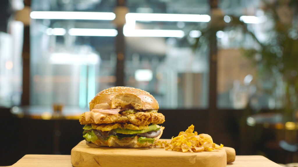 SuperMeat's chicken burger, pilot plant in the back