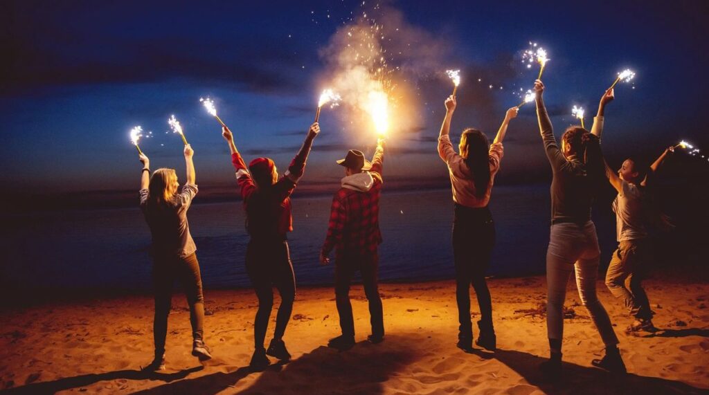 Friends on beach with flares