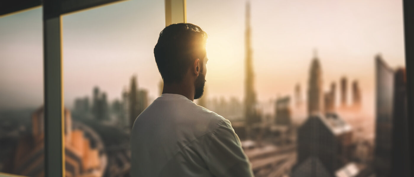 Man looking our of window at Dubai