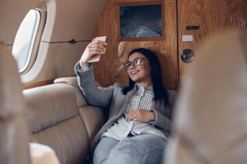 Woman taking selfie in private jet