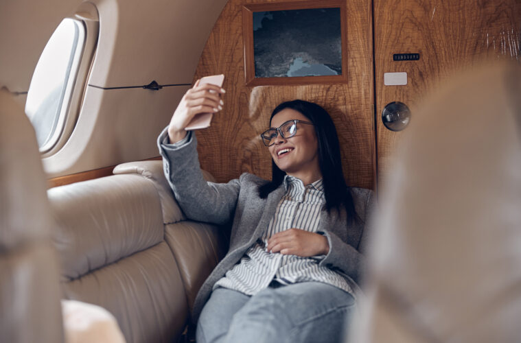 Woman taking selfie in private jet