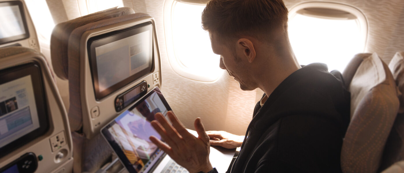 Man working on laptop on plane