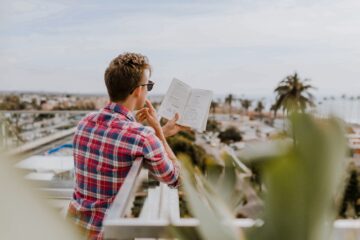 Man reading on balcony