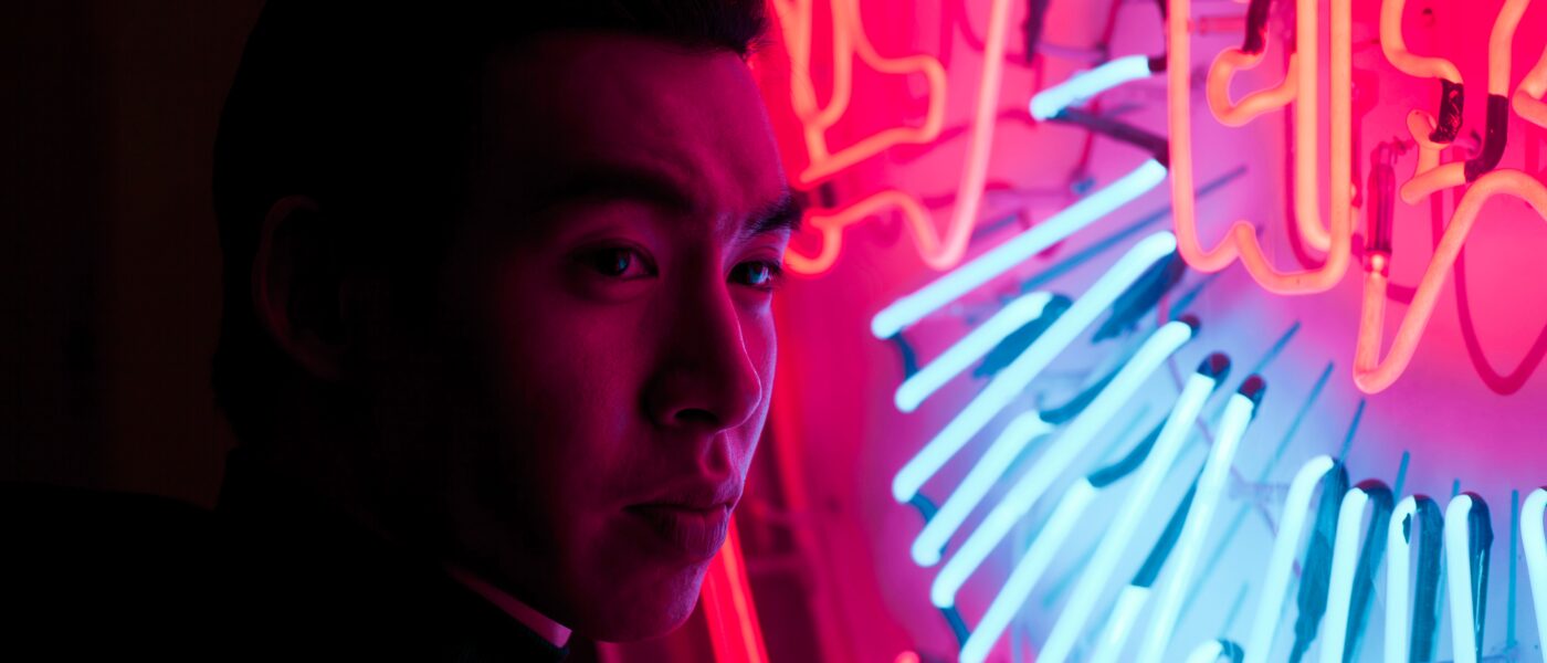 Chinese man with neon sign