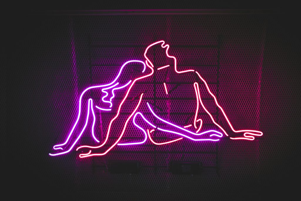 Neon figures embracing