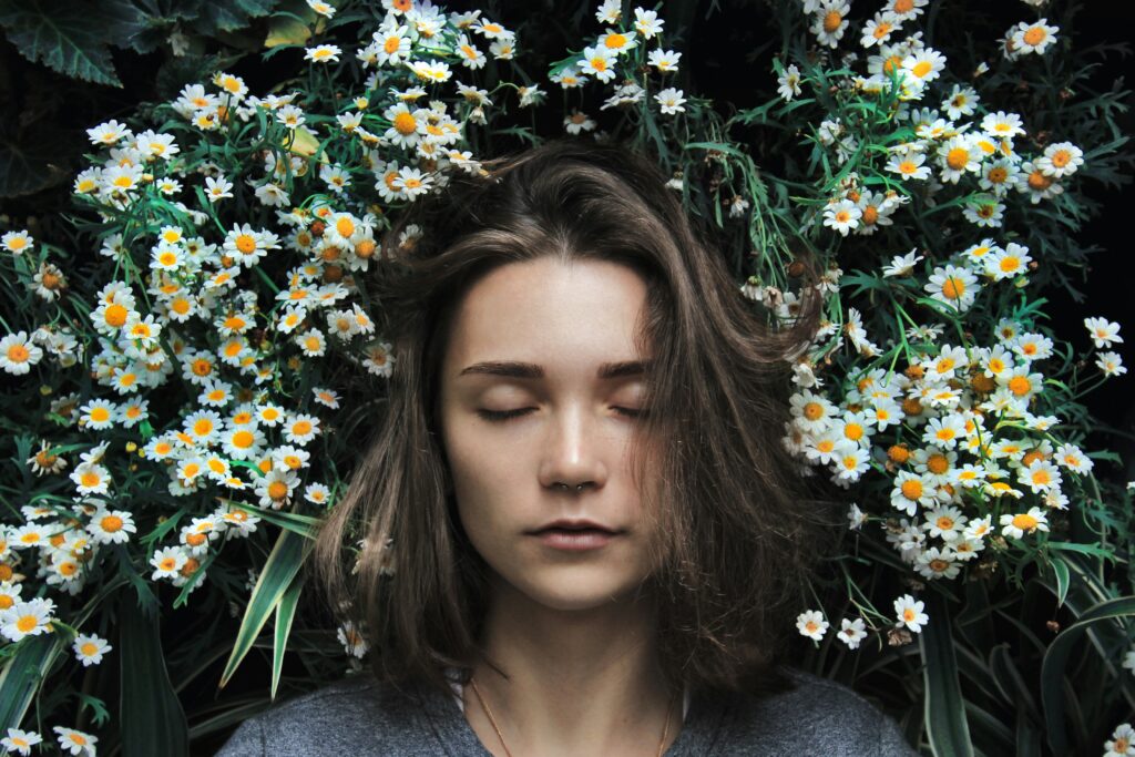 Woman asleep in daisies