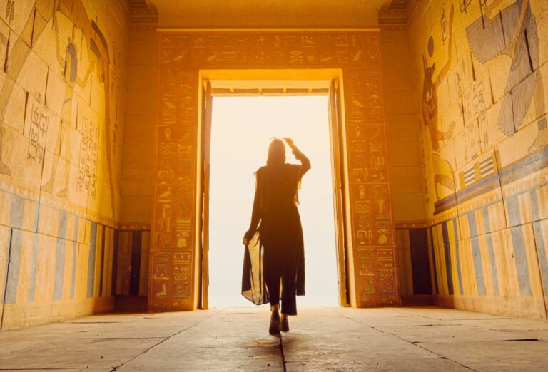 Woman walking through Egyptian tomb
